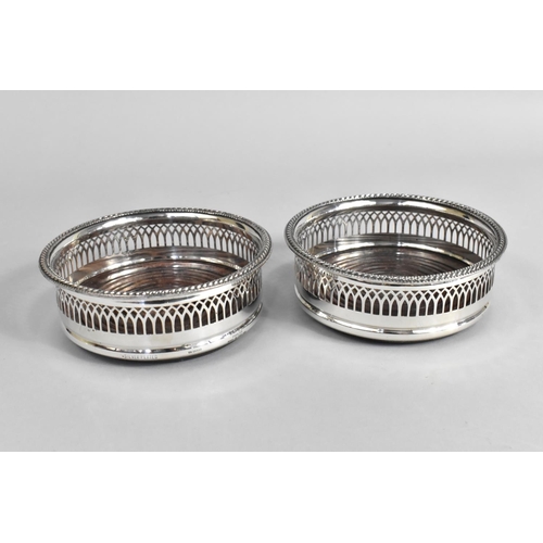 33 - A Pair of Silver Plated Bottle Coasters with Pierced Borders, 15cms Diameter