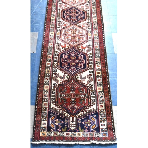 483 - A Persian Patterned Woollen Runner, 290x74cms