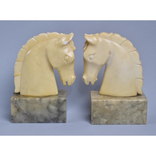 68 - A Pair of Carved Alabaster Bookends in the Form of Horses Heads, 16cms High