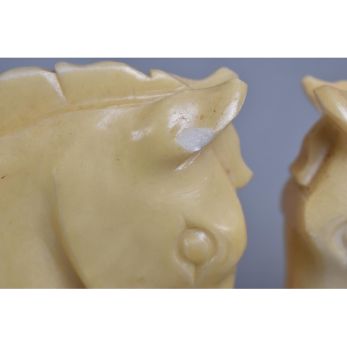 68 - A Pair of Carved Alabaster Bookends in the Form of Horses Heads, 16cms High