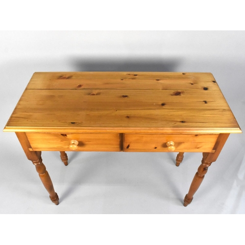 125 - A Modern Two Drawer Pine Side Table on Turned Supports, 96cms Wide