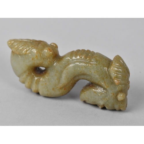 22 - A Carved Oriental Faux Jade Double Ended Serpent with Cicada and Mask Ends, 9cms Long