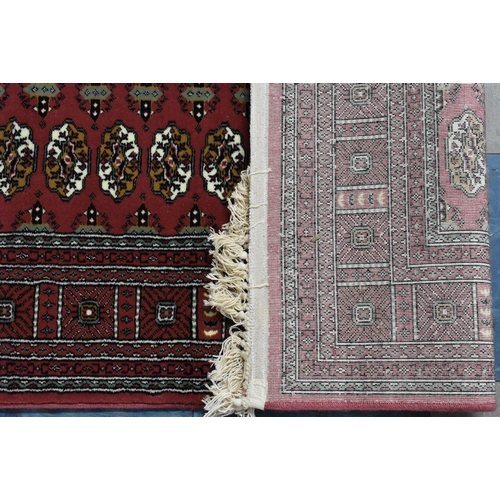 426 - Two Patterned Rugs on Red Ground, 120x170cms