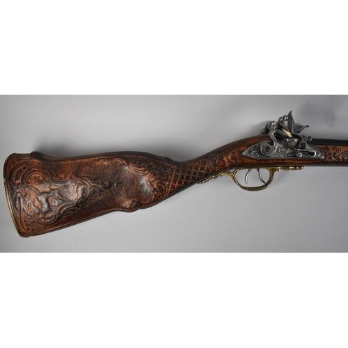 93 - A Replica Flintlock Double Barrelled Rifle with Carved Wooden Stock and Brass Trigger Guard