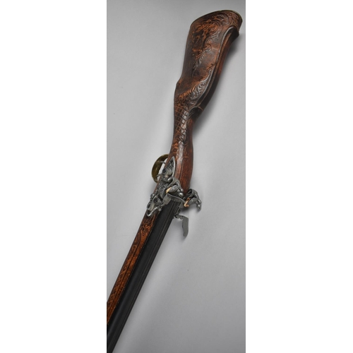 93 - A Replica Flintlock Double Barrelled Rifle with Carved Wooden Stock and Brass Trigger Guard