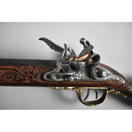 93 - A Replica Flintlock Double Barrelled Rifle with Carved Wooden Stock and Brass Trigger Guard