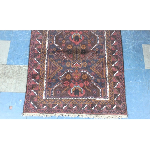 487 - A Vintage Bokhara Type Pattern Rug on Burgundy Ground, 194x104cm