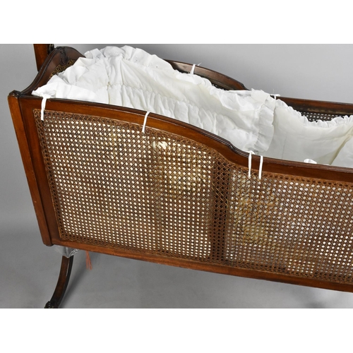 492 - A Mahogany Cane Panelled Rocking Cradle on Turned Reeded Supports, 117cms Long