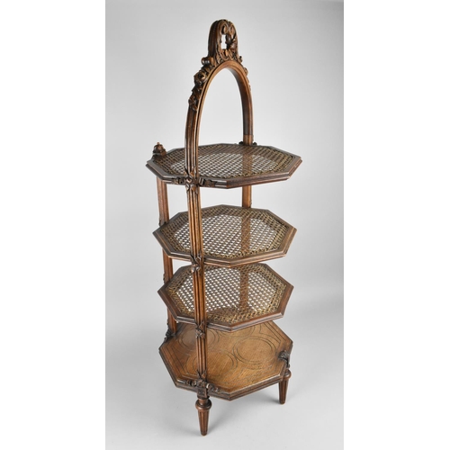 67 - A Four Tier Cake Stand with Three Cane Shelves and Base Carved Shelf, Carved Carrying Handle, 93cms ... 