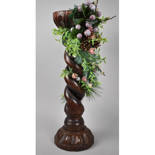 105 - A Carved Wooden Open Spiral Plant Stand Decorated with Artificial Flowers and Fruit, 48cms High