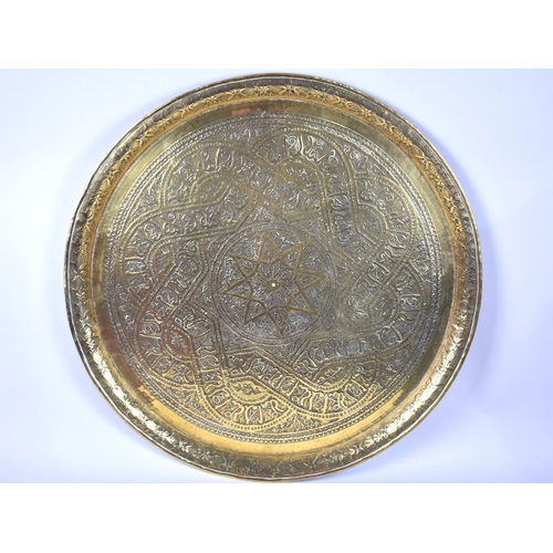 127 - A Large Indian Brass Benaries Tray Top with Engraved Islamic Decoration, 59cms Diameter