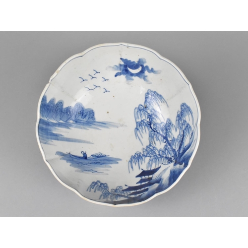 237 - A Qing Period Chinese Blue and White Bowl of Lobed Form Decorated with River Village Scene, Having H... 