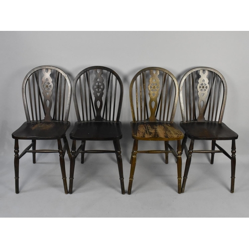 515 - A Set of Four Mid 20th Century Wheel Back Dining Chairs