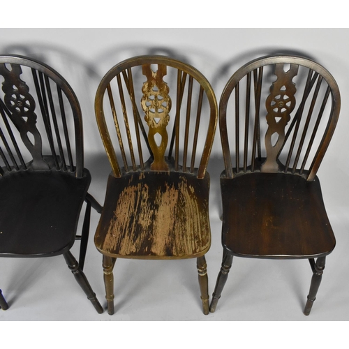 515 - A Set of Four Mid 20th Century Wheel Back Dining Chairs