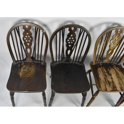 515 - A Set of Four Mid 20th Century Wheel Back Dining Chairs