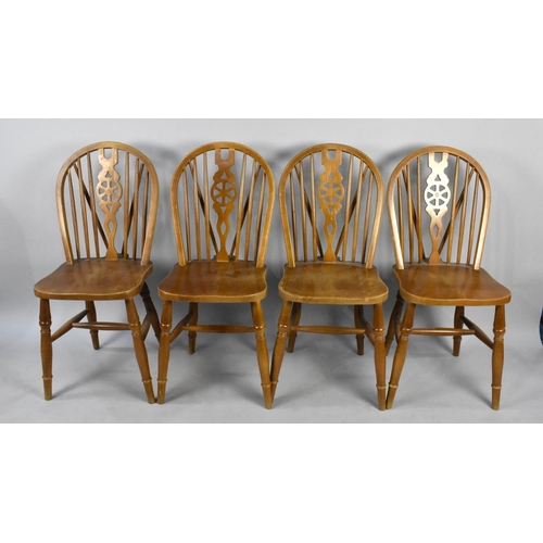 517 - A Set of Four Wheel Back Dining Chairs