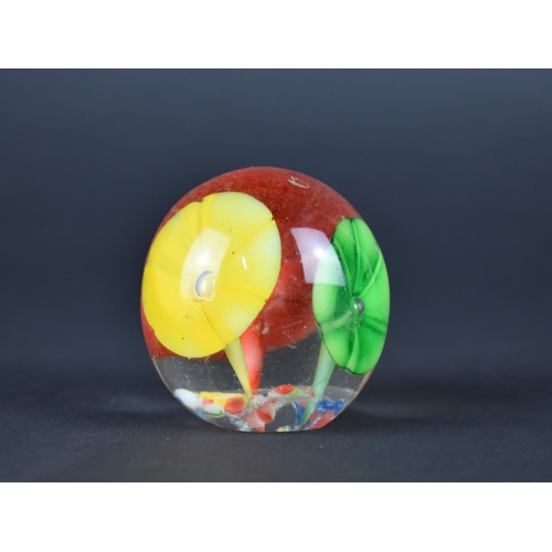 438 - A Small Glass Paperweight Decorated with Flowers, 4.5cms High