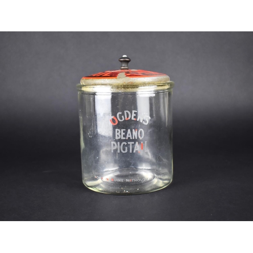 103 - An Ogden's Beano Pigtail Glass Advertising Pot with Painted Tin Plate Lid, 17cms High