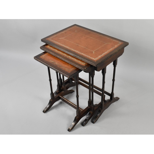 112 - A Nest of Mahogany Tables with Tooled Leather Top, 51cm Wide