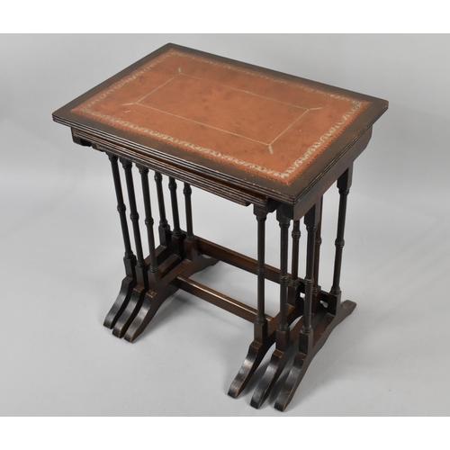 112 - A Nest of Mahogany Tables with Tooled Leather Top, 51cm Wide