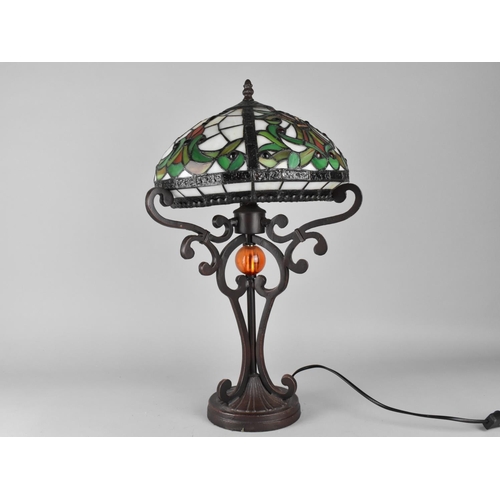 147 - A Tiffany Style Table Lamp on Bronzed Supports, 51cms High