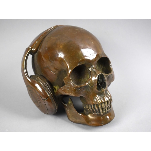 157 - A Cast Bronze Study of a Skull with Headphones