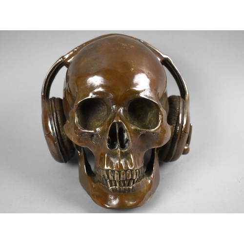 157 - A Cast Bronze Study of a Skull with Headphones