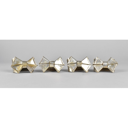 169 - A Set of Four Silver Plated Napkin Rings in the Form of Bows