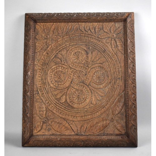 175 - A Carved Oak Panel with Floral and Geometric Design, 56cms Wide