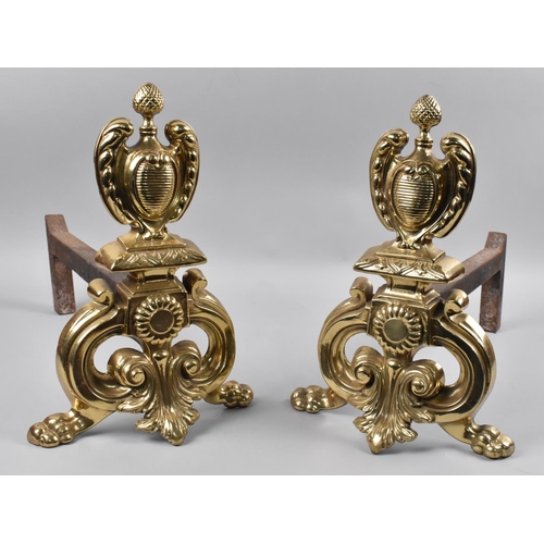 268 - A Pair of Early 20th Century Polished Brass Fire Dogs in the Rococo Style, Pineapple Finial and Wing... 