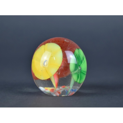 438 - A Small Glass Paperweight Decorated with Flowers, 4.5cms High