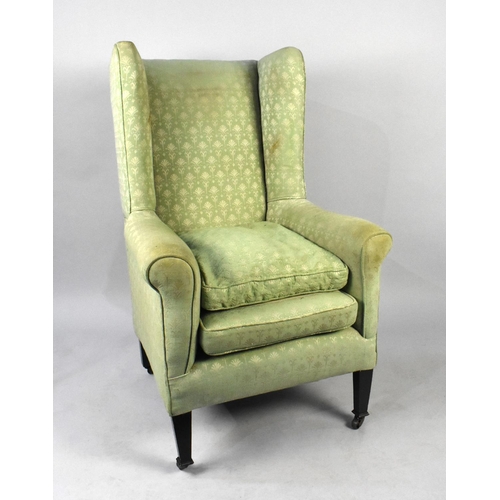 529 - A George III Style Wingback Fireside Armchair on Castor Supports