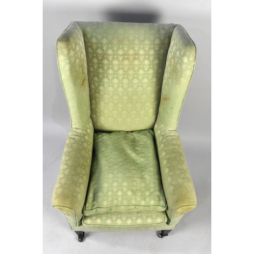 529 - A George III Style Wingback Fireside Armchair on Castor Supports