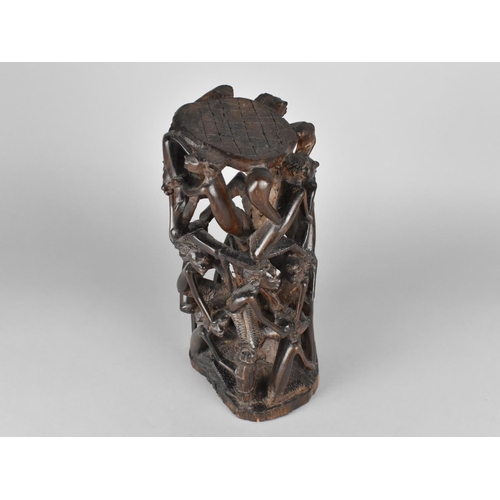 71 - An African Hardwood Carving/Stand, In a Round with Figures, 27cms High