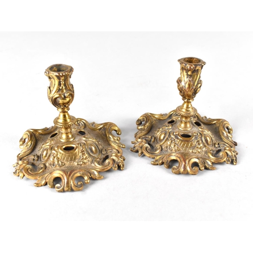 72 - A Pair of Brass Candlesticks with Ornate Scrolled and Pierced Base and Acanthus Holders, 7.5cms High