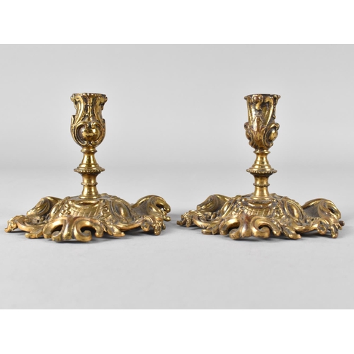 72 - A Pair of Brass Candlesticks with Ornate Scrolled and Pierced Base and Acanthus Holders, 7.5cms High