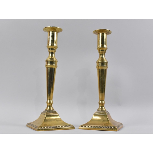 77 - A Pair of 19th Century Brass Candlesticks on Square Tapering Bases, 25cms High