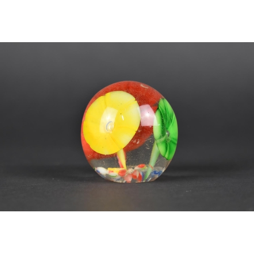 438 - A Small Glass Paperweight Decorated with Flowers, 4.5cms High