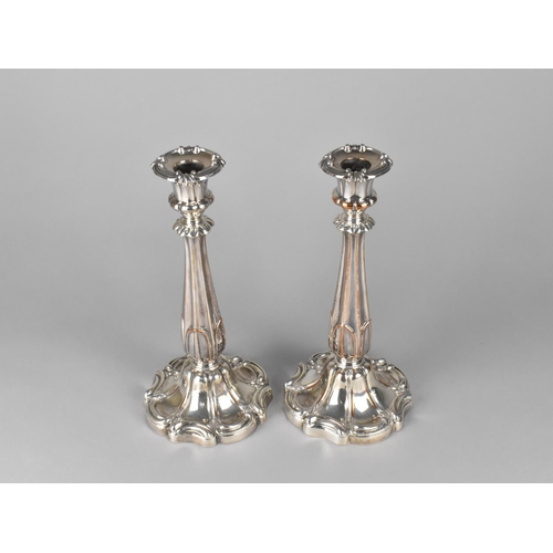 102 - A Pair of Sheffield Plated Candlesticks with Acanthus Supports, 26cms High