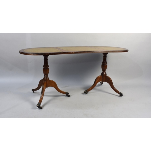 184 - A Mahogany and Tooled Leather Topped Coffee Table on Turned Vase Supports and Coaster Feet, 114cms W... 