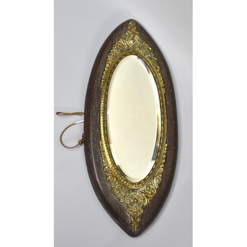 186 - A Late Victorian/Edwardian Oval Oak and Ornate Brass Framed Mirror with Bevelled Glass, 52cms High