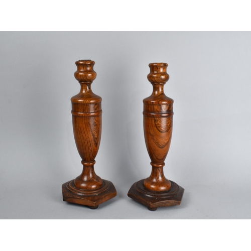 222 - A Pair of Turned Wooden Candlesticks with Vase Supports on Hexagonal Bases, 30cms High