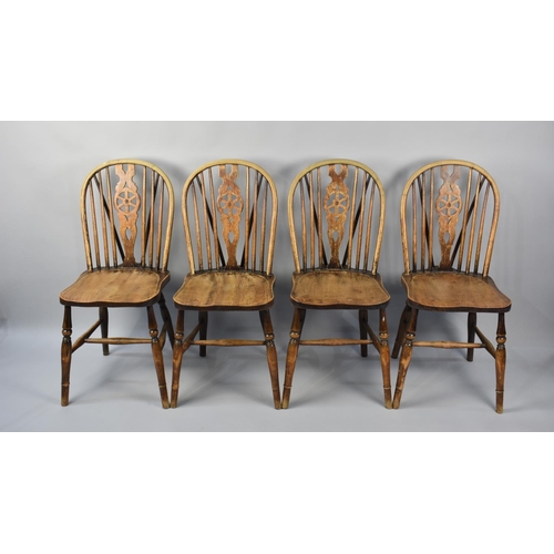 500 - A Set of Four Wheel backed Dining Chairs in Need of Some Restoration