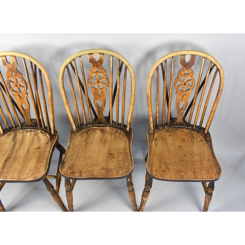 500 - A Set of Four Wheel backed Dining Chairs in Need of Some Restoration