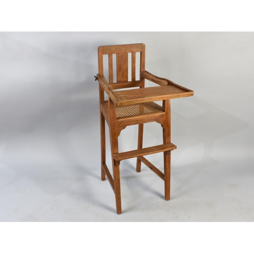 504 - A Mid 20th Century Cane Seated Child's Highchair with Hinged Tray