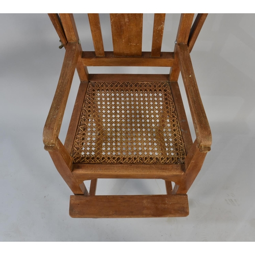 504 - A Mid 20th Century Cane Seated Child's Highchair with Hinged Tray