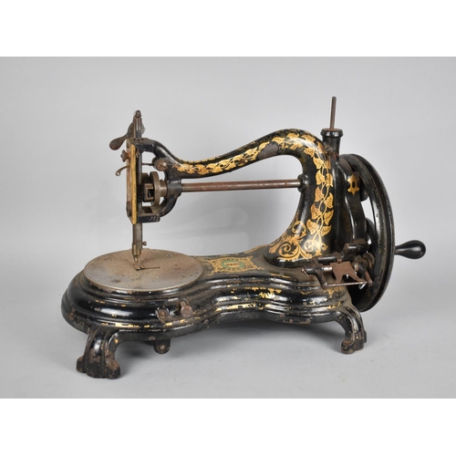 81 - A Late Victorian/Edwardian Jones Manual Sewing Machine with Gilt Painted Foliage Decoration on Black... 