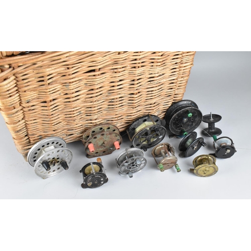 A Wicker Fishing Creel Containing Various Vintage Reels to include