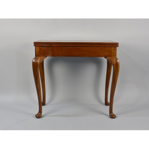 94 - A Mahogany Games Table on Cabriole Supports Culminating to Pad Feet, 77.5cms High by 81cms Wide