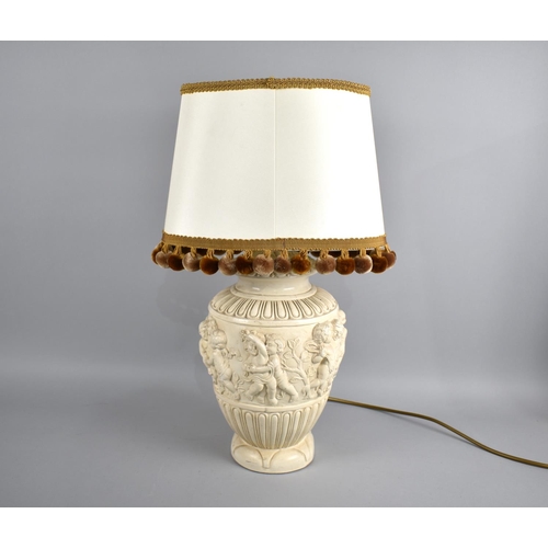 228 - A Continental Relief Decorated Table Lamp, With Shade